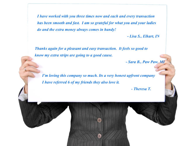 Person holding cardboard with customer reviews printed on it