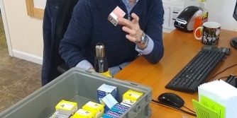 Man holding a box of diabetic test strips