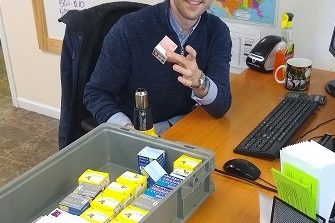 Man holding a box of diabetic test strips