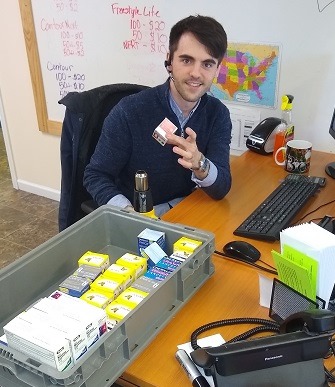 Man holding a box of diabetic test strips